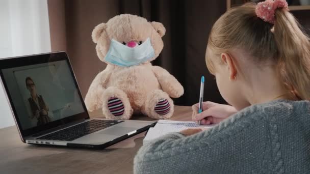 Ein Kind hört zu Hause einer Online-Lektion zu — Stockvideo
