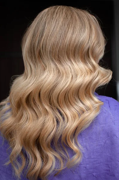 Μακριά μαλλιά μιας ξανθιάς γυναίκας με κυματικό χτένισμα — Φωτογραφία Αρχείου