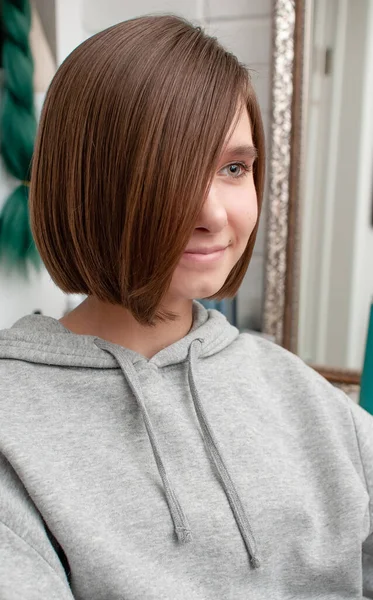 Haircut on a teenager girl in a beauty salon close-up