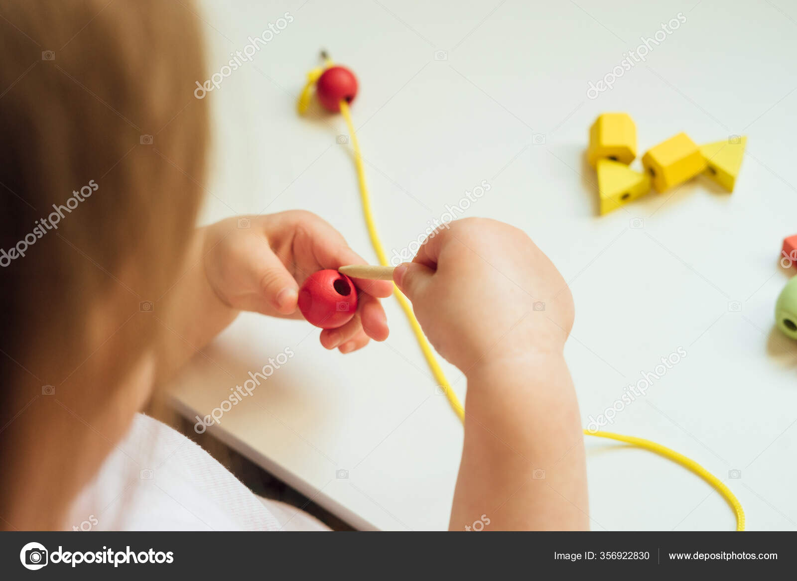 Child Putting Beads String Bead Stringing Activity Fine Motor Skills Stock Photo by ©Kaloriya