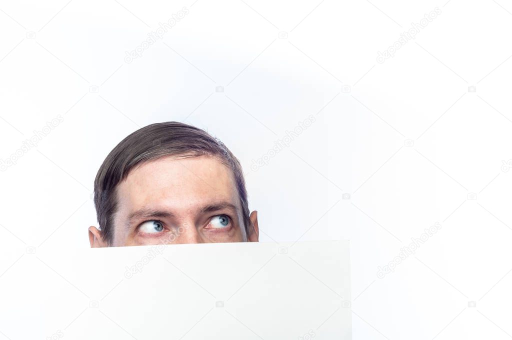 The person's face is covered with a white piece of paper, on an 