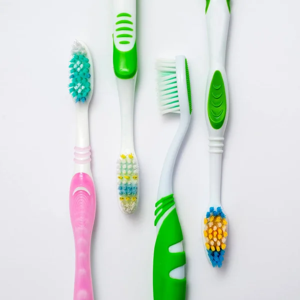 Various toothbrushes on a white backgroun — Stock Photo, Image