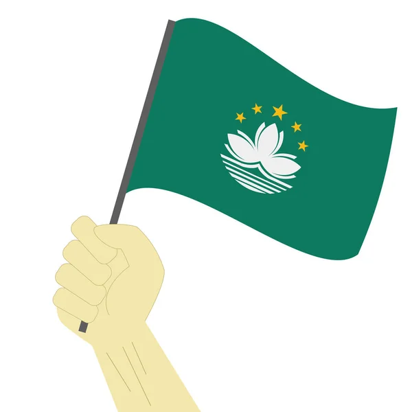 Mão segurando e levantando a bandeira nacional de Macau — Vetor de Stock