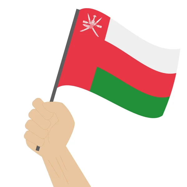 Hand holding en verhoging van de nationale vlag van Oman — Stockvector