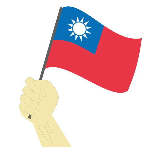 Mão segurando e levantando a bandeira nacional de Taiwan — Vetor de Stock