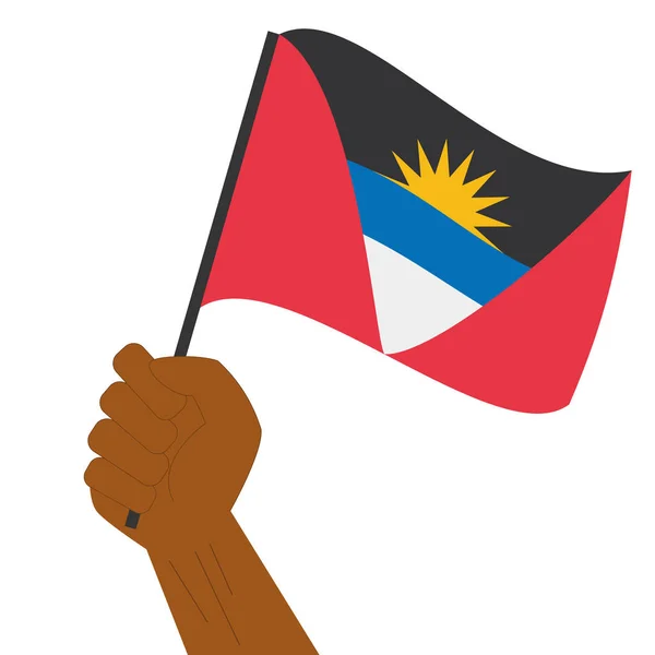 Hand holding en verhoging van de nationale vlag van Antigua en Barbuda — Stockvector