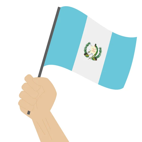 Hand holding en verhoging van de nationale vlag van Guatemala — Stockvector