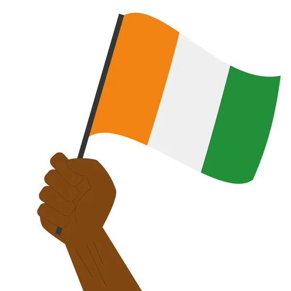 Hand halten und die Nationalflagge der Elfenbeinküste hissen — Stockvektor