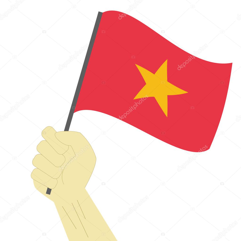 Hand holding and raising the national flag of Vietnam