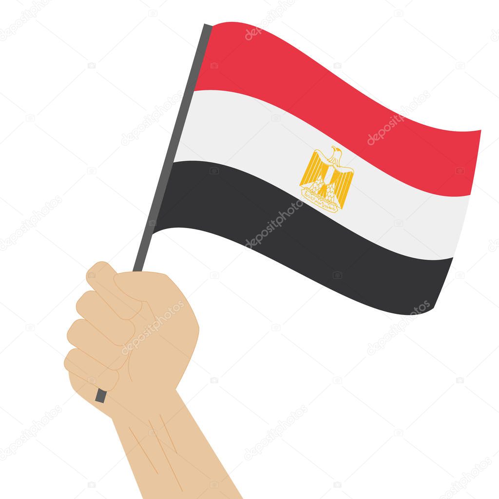 Hand holding and raising the national flag of Egypt