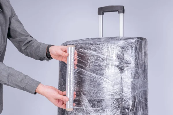 Man Wraps Suitcase Protective Transparent Film — Stock Photo, Image