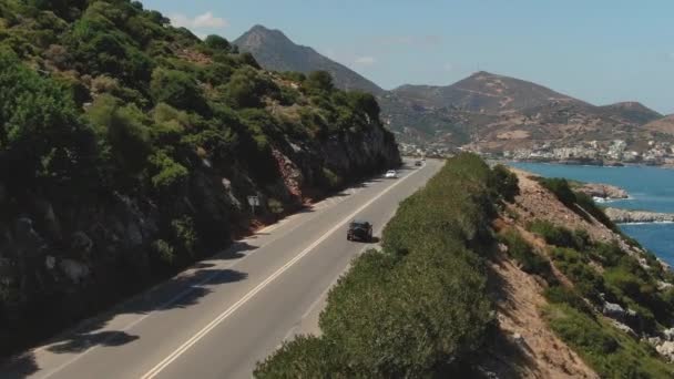 Top Luchtfoto van een rode auto rijden op de weg in de buurt van zee. Luchtfoto Drone van auto 's rijden op strand en kust rooad. — Stockvideo