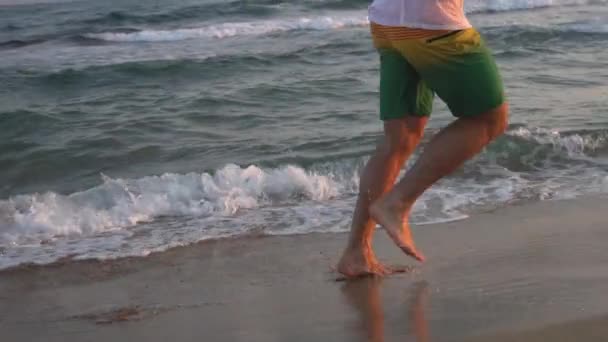 A Man Runs In Sneakers On A Sandy Beach By The Sea. Slow Motion, — Stock Video