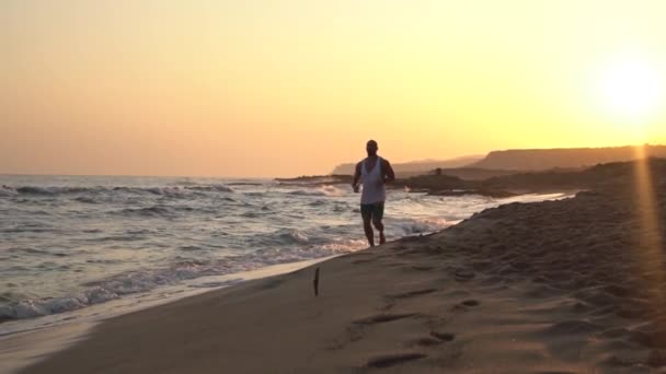 Lonely Sport Man Running, Jogging On Empty Sea Beach Against Sunset, Slow — Stock Video