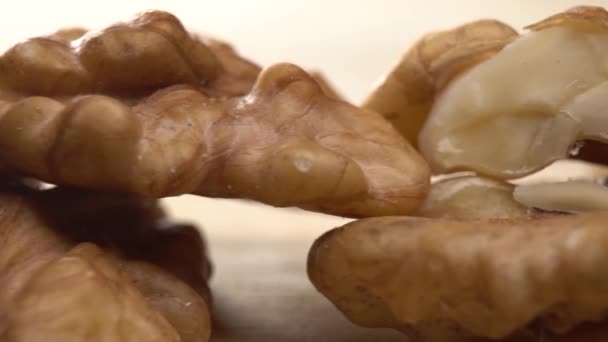 Walnut close up moving . product rich in minerals and vitamins. Walnut turns in a shot. walnut close up lies under beams of the sun. Macro Healthy Super Food — Stock Video