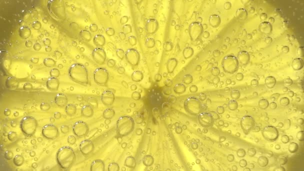 Macro shot of a lime slice in water bubbles — Stock Video