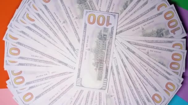 Many dollars are rotating. Spinning background of money. Hape of cash turning. Beautiful rich background with 100 dollar bills. Pile american bucks. You can write your title or logo on our background. — Stockvideo