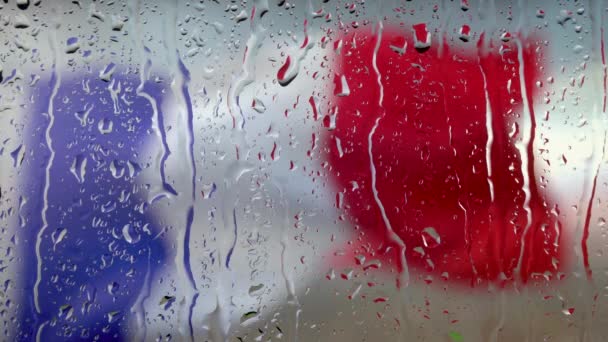 Wiele kropli wody na szybę okienną podczas ulewnego deszczu. Widok z bliska Flaga francuska — Wideo stockowe