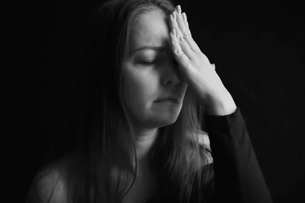 headache and depression, black and white portrait of a tired woman