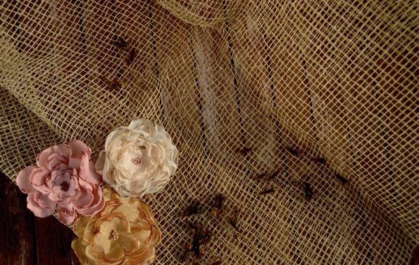 background of decorative mesh with textile flowers
