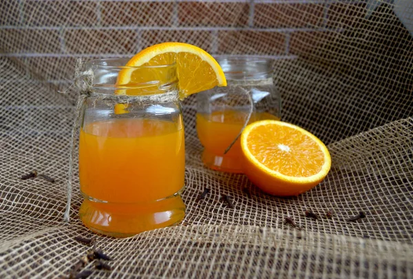 a glass of orange juice with an orange slice