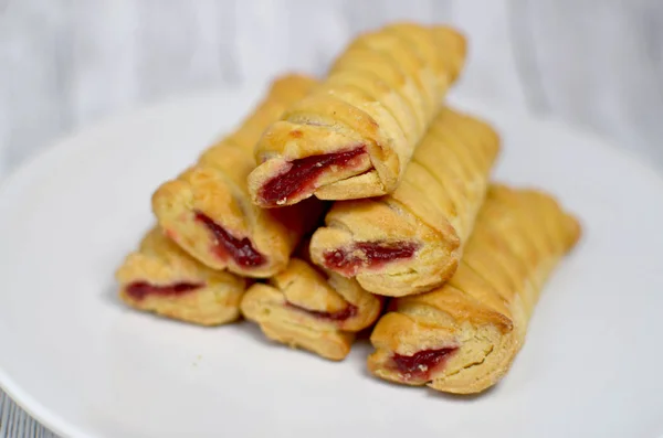 Sweet biscuits with jam on a white plate