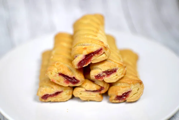 Sweet biscuits with jam on a white plate