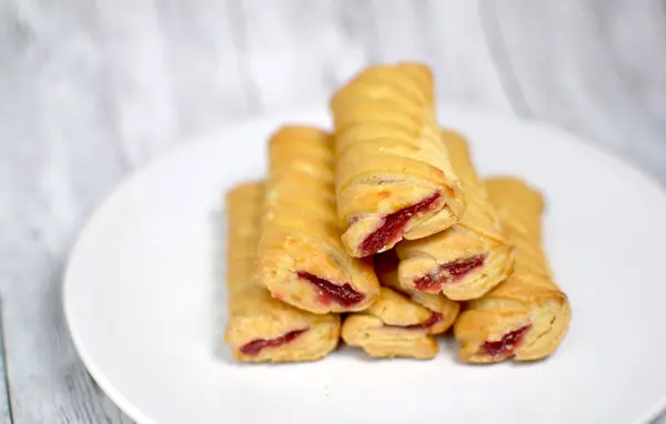 Sweet biscuits with jam on a white plate