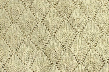 Eşkenar dörtgenlerle örgü dokusu. Bej arkaplan