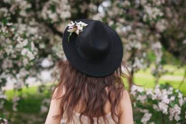 Portre güzel arkadan görünüm esmer kadının çiçek arka plan üzerinde 