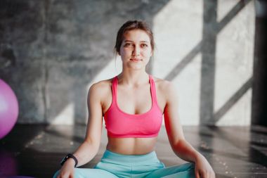 Woman practicing yoga in lotus pose clipart