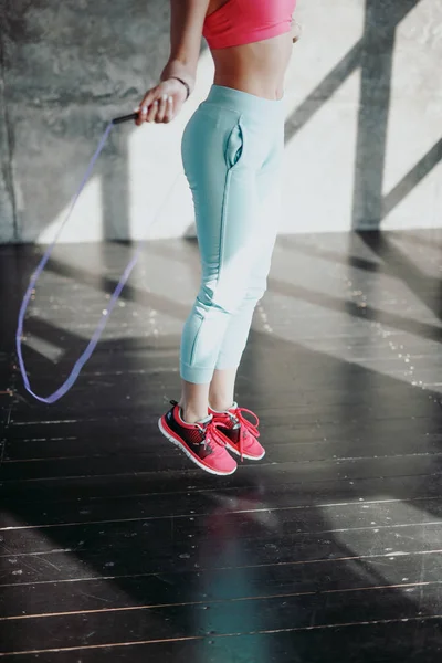 Woman jumping with skipping rope — Stock Photo, Image