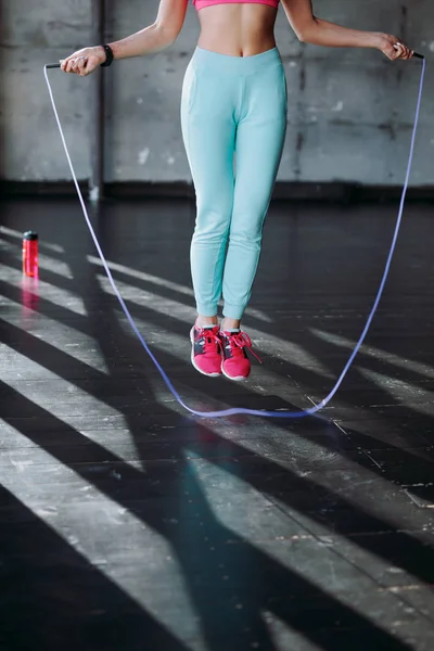 Woman jumping with skipping rope — Stock Photo, Image