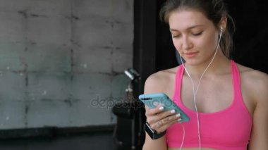 Spor salonunda Smartphone kullanan kadın