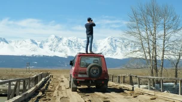 Man On Road Trip Sit On Convertible Car Taking Photo (en inglés). 20s 4k — Vídeos de Stock