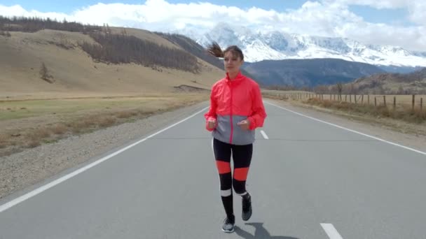 Woman running on open road — Stock Video