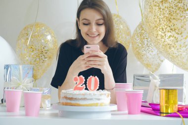 Akıllı telefon tutan genç bir kadın. 