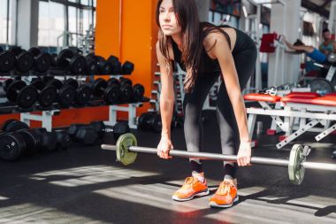 Kadının omuz basın egzersiz ile kilo bar salonunda yapması