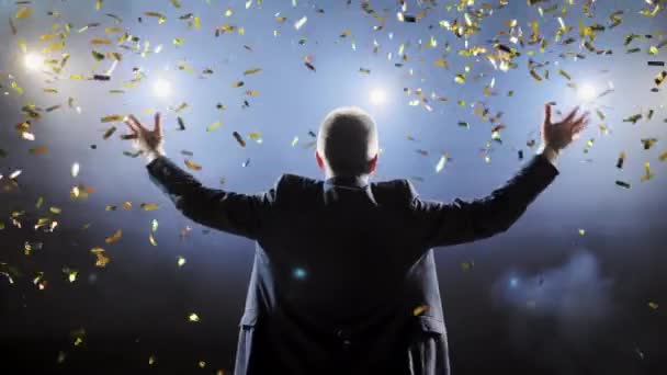 Successful businessman with arms up celebrating his victory. Celebrating success. Low angle view of excited young businessman keeping arms raised and expressing positivity while stands on the stage. — Stock Video