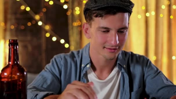 Handsome guy is using a digital tablet while sitting at the bar counter in pub — Stock Video