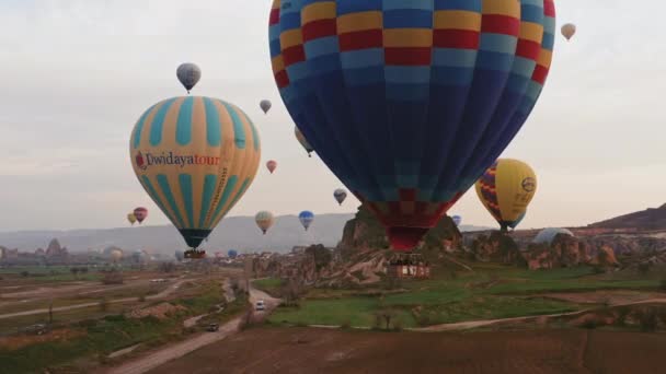 Goreme, Turkey - 17 жовтня 2009: Комерційна повітряна куля, що літає над кам'яними утвореннями поблизу міста Горем (Каппадокія, Туреччина). — стокове відео