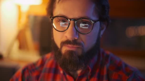 Portrait Of a Man Is Working On Laptop Computer With Glasses At Night Close Up. Businessman Working Late At Night Looking At Monitor, Reflections In Glasses. Looking Up To The Camera. — Stock Video