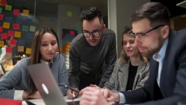 Collega 's en klanten praten strategie met laptop en tablet. In Creative Office Productieve medewerkers staan aan de tafel voor Company Meeting. Teamwork en sociale concepten — Stockvideo