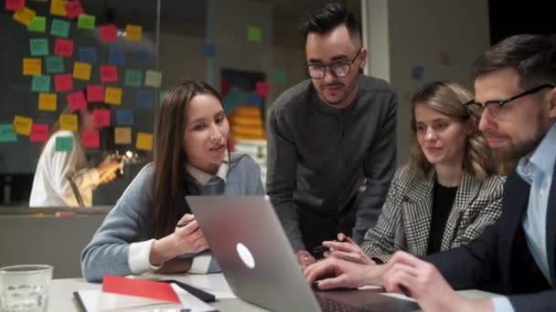 Kollegor och kunder talar strategi med laptop och surfplatta. I Creative Office Produktiva medarbetare som står vid bordet för företagsmöte. Lagarbete och sociala begrepp — Stockvideo