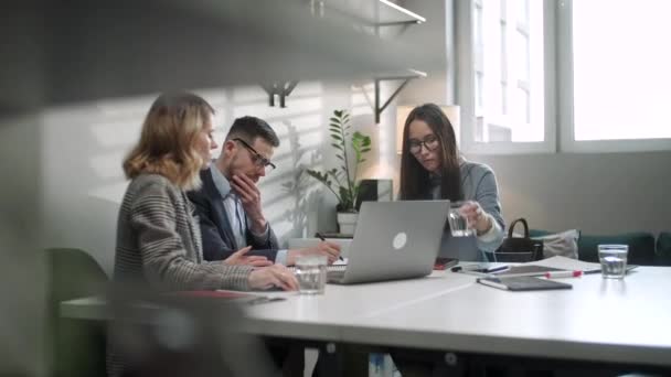 Dans Creative Office Productive Coworkers Standing at the Table, Company Meeting. Chers collègues et clients parlant stratégie avec ordinateur portable et tablette. — Video