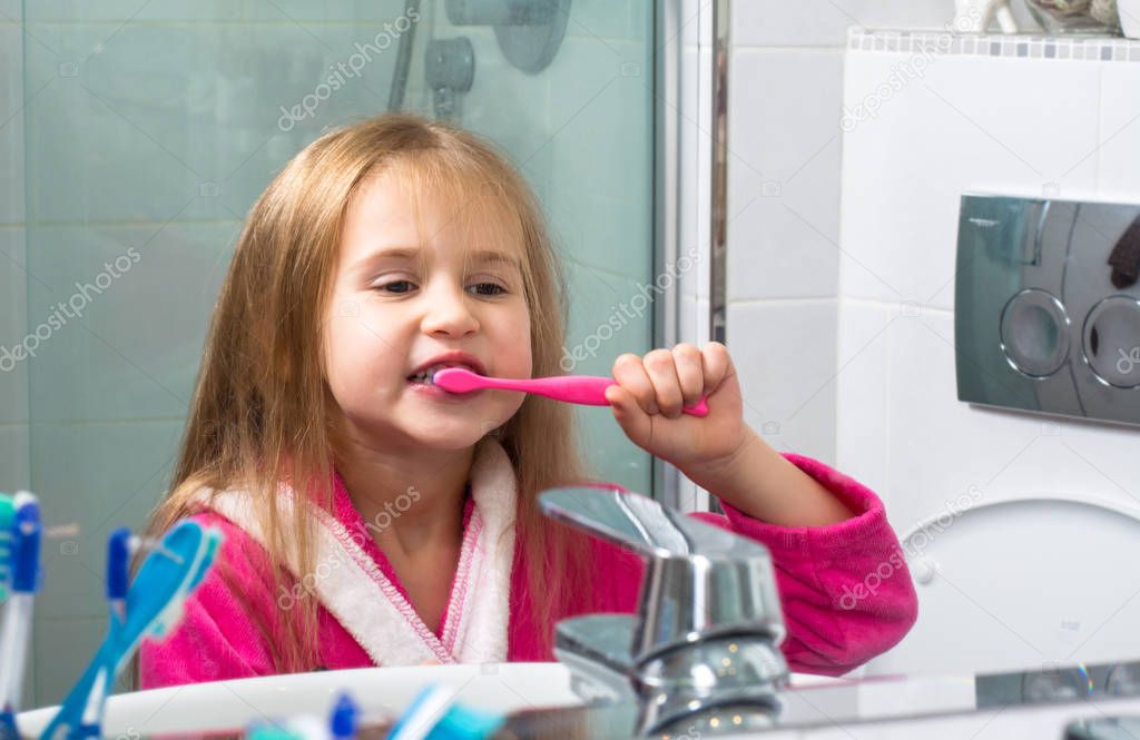 Baby Girl Brushing Her Teeth in the Morning at Bathroom