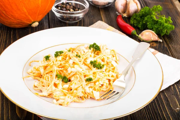 Pumpkin salad with egg, garlic and mayonnaise on a white plate — Stock Photo, Image