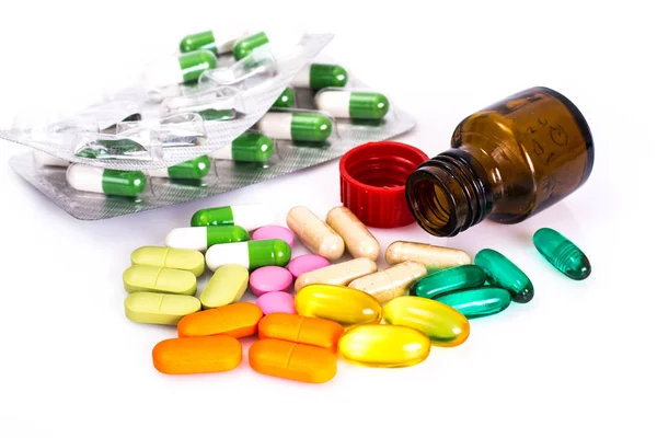Gekleurde capsules, pillen en medische glazen fles — Stockfoto