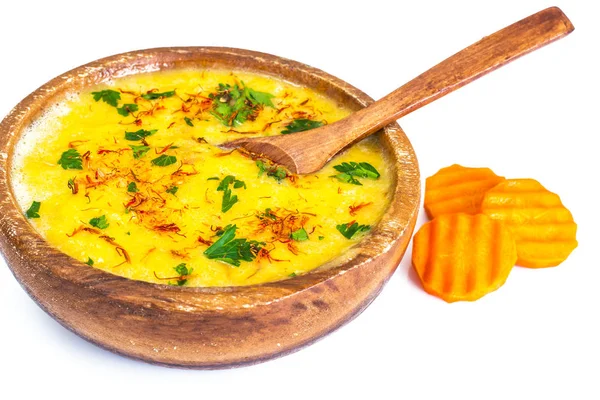 Pumpkin cream soup with saffron and parsley in a wooden bowl — Stock Photo, Image