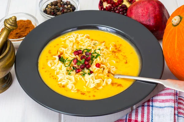 Soupe à la crème de légumes avec nouilles, curry et grenade — Photo